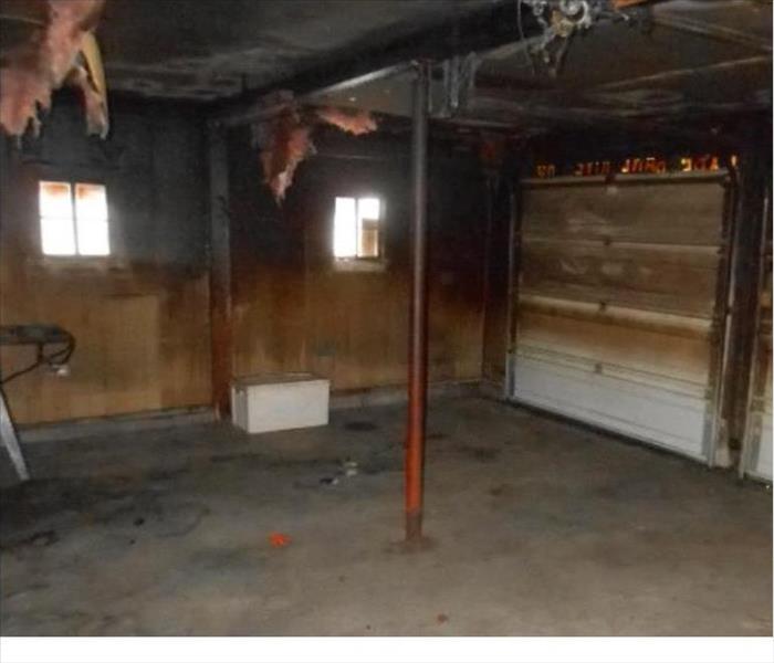 hanging insulation, charred walls in a garage