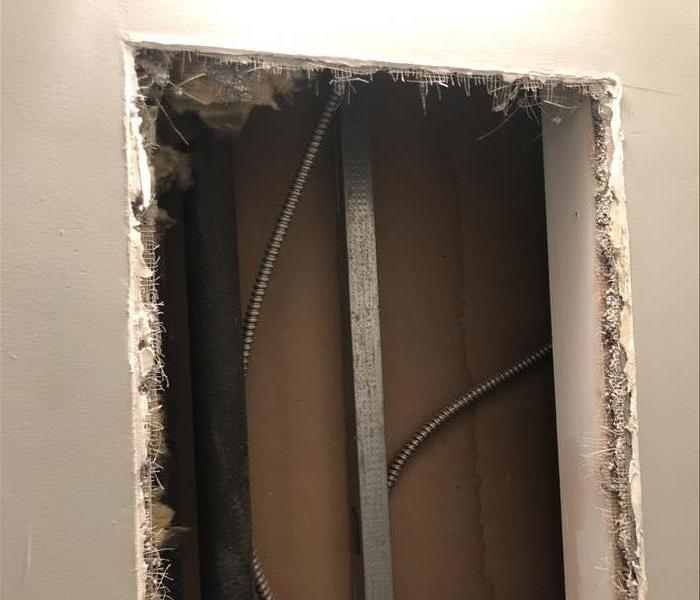 removed wallboard showing electrical conduit