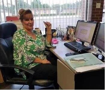 photo of Cindy sitting at her desk
