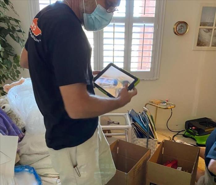 SERVPRO technician beside boxes with household items