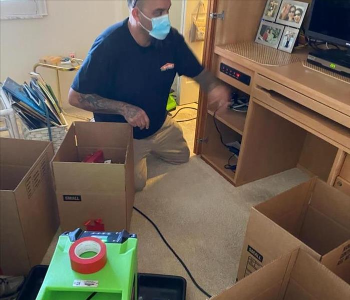 SERVPRO tech with boxes for pack-out with common household items