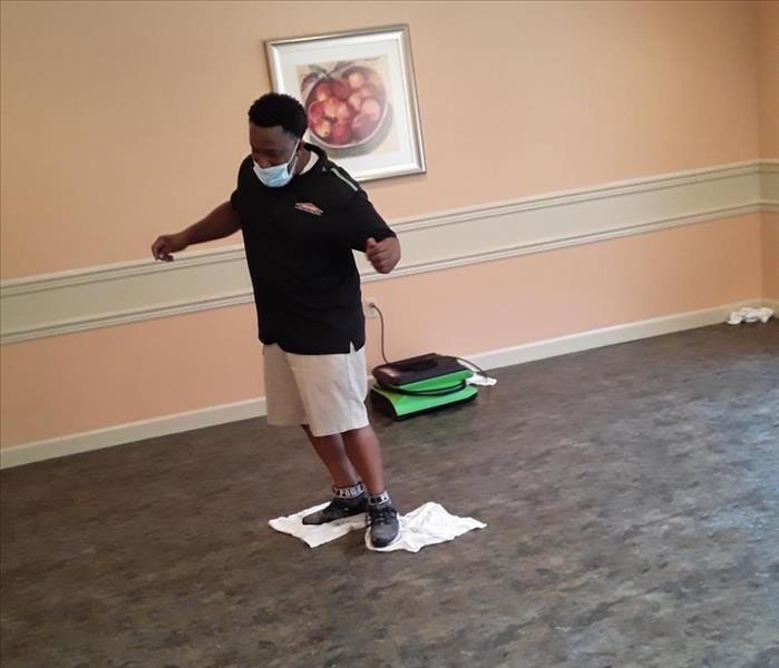 SERVPRO technician handling water damage in a commercial building